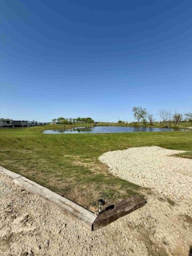 RV pads near the water - blue skies and green grass